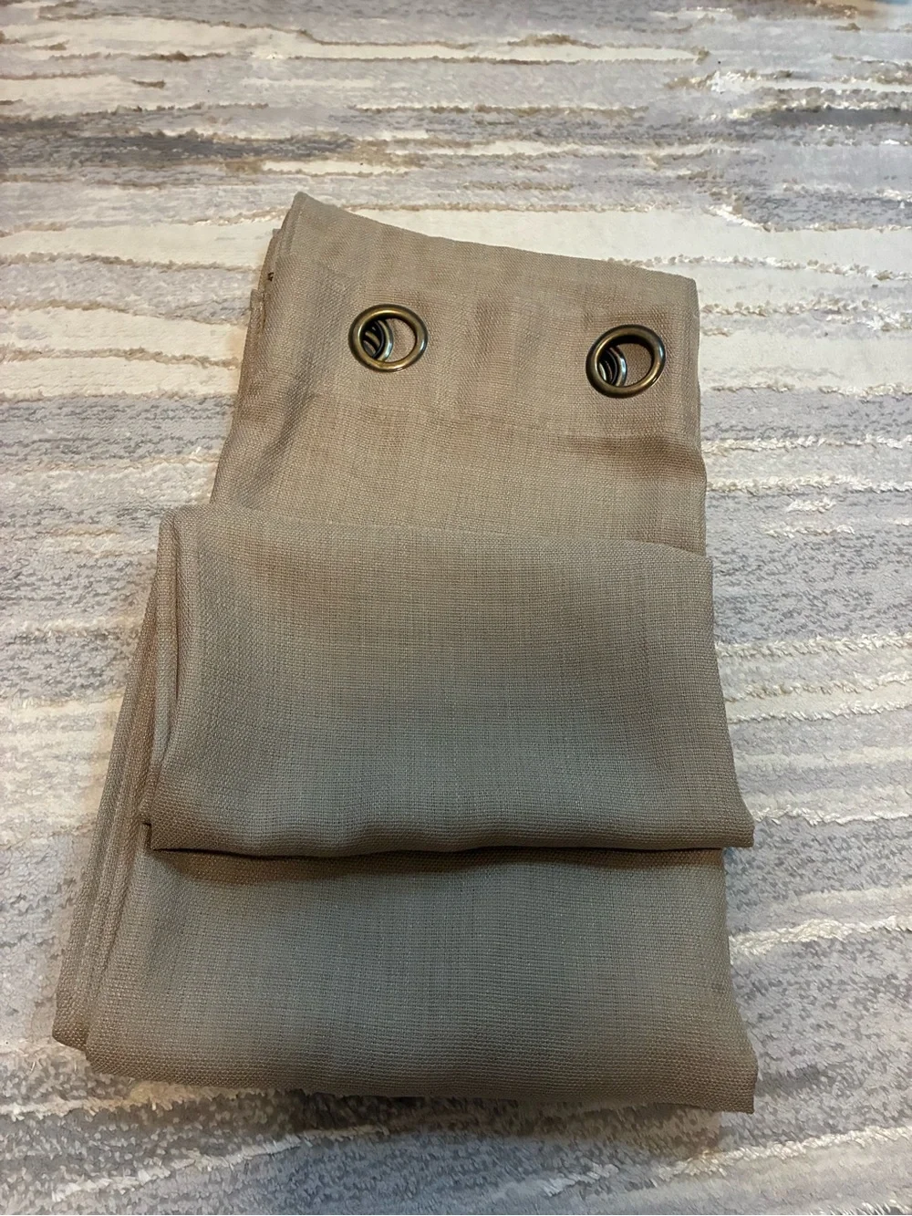 Tan grommet-top curtain panel measures approximately 90 in length 50 width. EUC